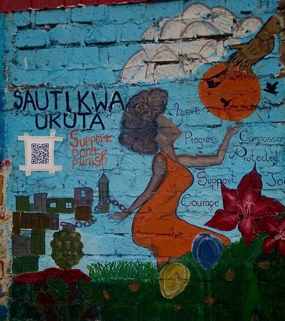 The Sauti kwa Ukuta mural in Githurai 45, Nairobi: a woman breaking free from chains, surrounded by the words love, progress, compassion, support and courage